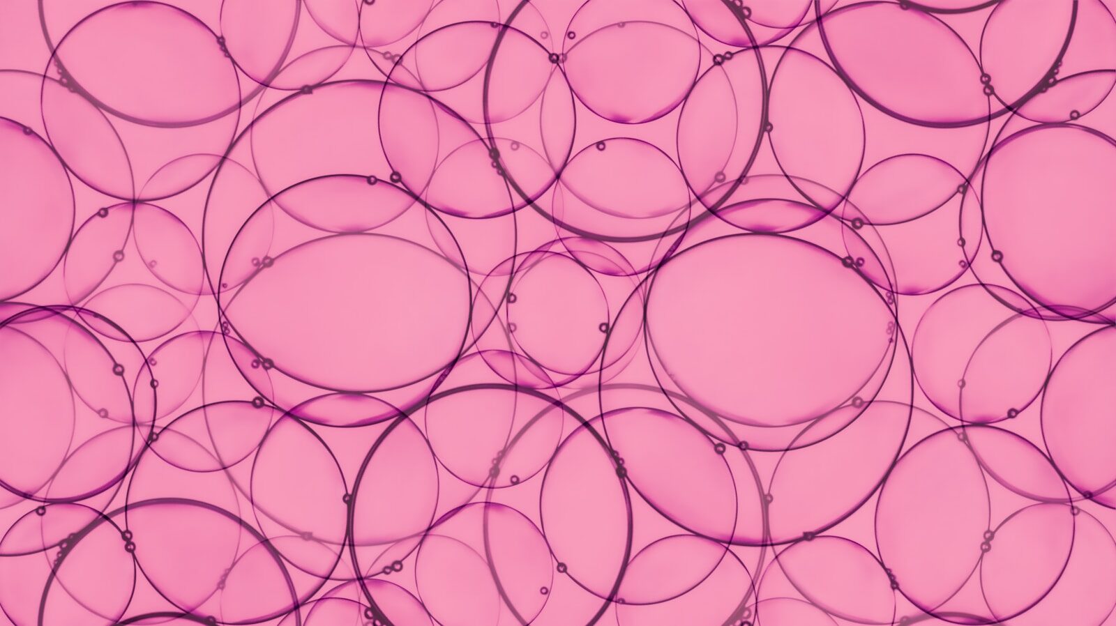 Overlapping pink bubbles create an abstract pattern.